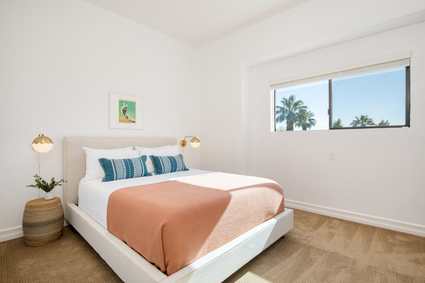 Bright bedroom with a plush bed and desert palm views