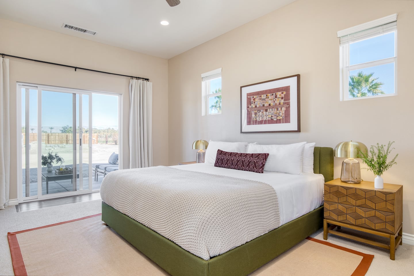 Bedroom with a green bed frame and sliding doors to the patio